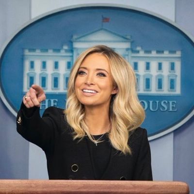 She is standing behind the podium addressing the crowd.